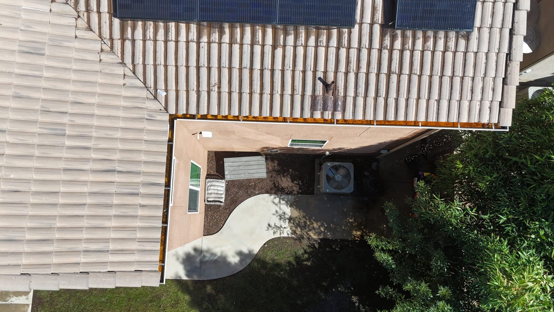 Clean gutter along tile roof edge after professional cleaning