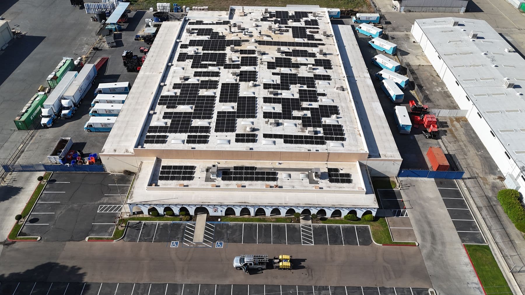 Drone view of a large commercial rooftop solar array